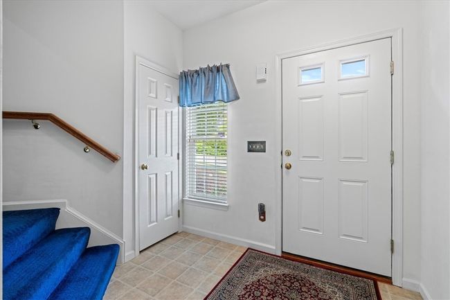 The entry is light and bright with neutral walls and flooring. Large window provides view of front yard. Coat closet for storage. | Image 5