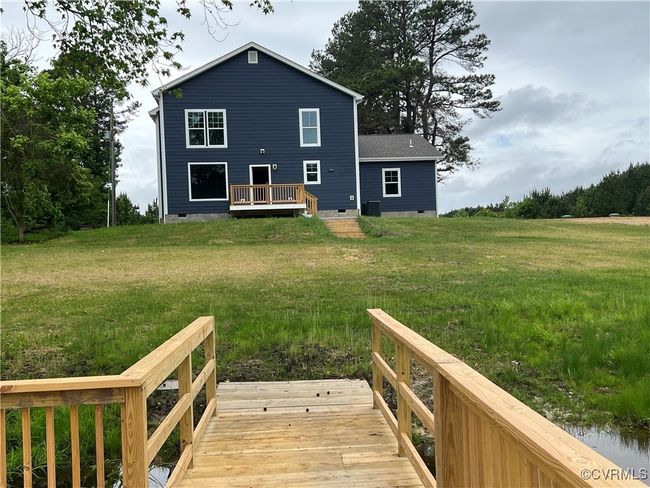 Back of property featuring a lawn, a wooden deck, and crawl space | Image 40