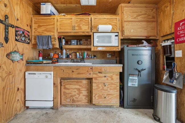 Kitchen in shop with a sink, microwave and dishwasher. | Image 31