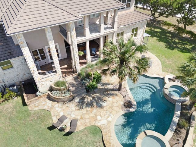 View of pool featuring a pool with connected hot tub, a yard, and a patio area | Image 32