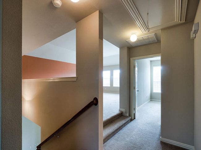Hallway with attic access, carpet, baseboards, and an upstairs landing | Image 33