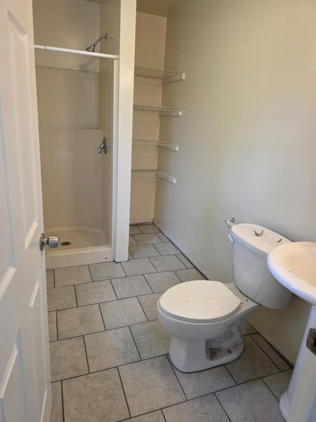 Full bath featuring a stall shower and tile patterned flooring | Image 17