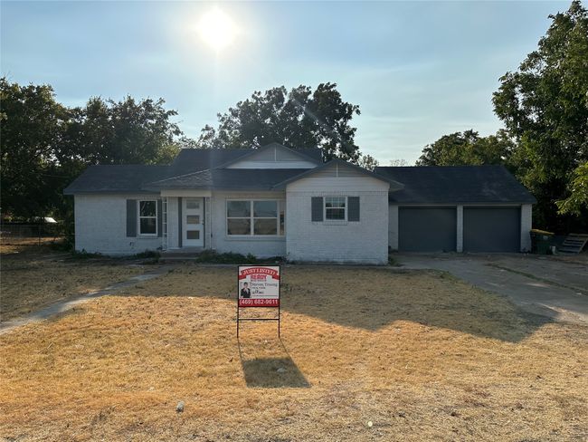 Single story home with concrete driveway, brick siding, a front yard, and a garage | Image 39