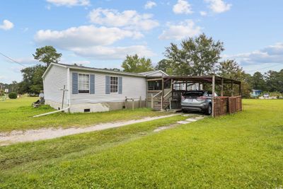 Manufactured / mobile home featuring a front yard and a carport | Image 2