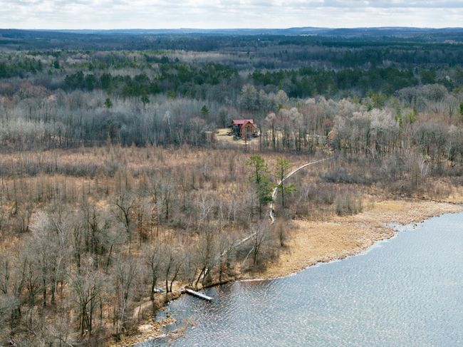This aerial view shows the dock and beach area with the cabins beyond. | Image 13