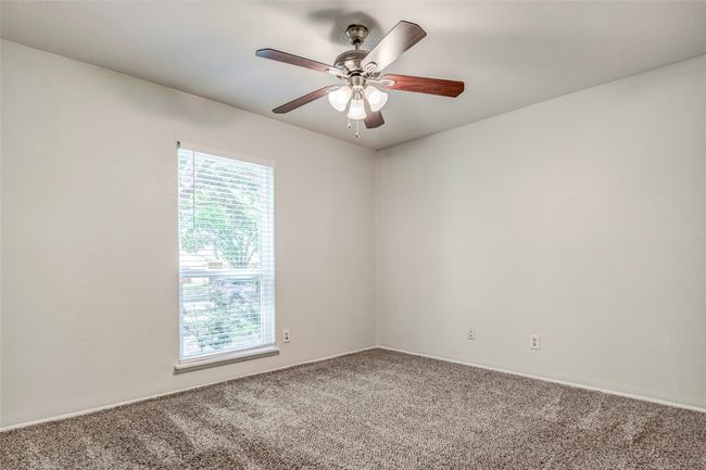 Carpeted empty room featuring ceiling fan and baseboards | Image 31