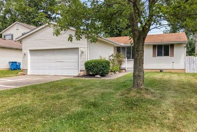 Single story home with a garage and a front yard | Image 1