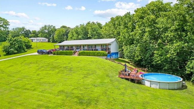 Rear view of house with a lawn and an outdoor pool | Image 32