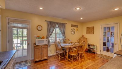 Dining space with a textured ceiling and light hardwood / wood-style flooring | Image 3