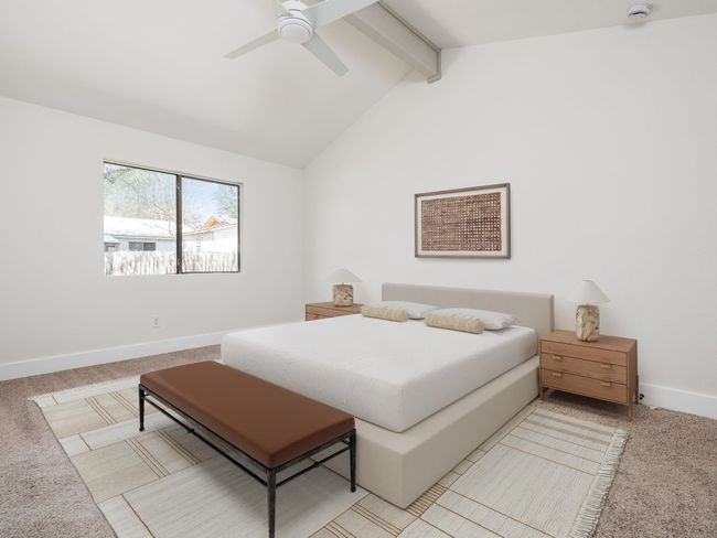 Bedroom featuring light colored carpet, vaulted ceiling with beams, baseboards, and a ceiling fan | Image 7