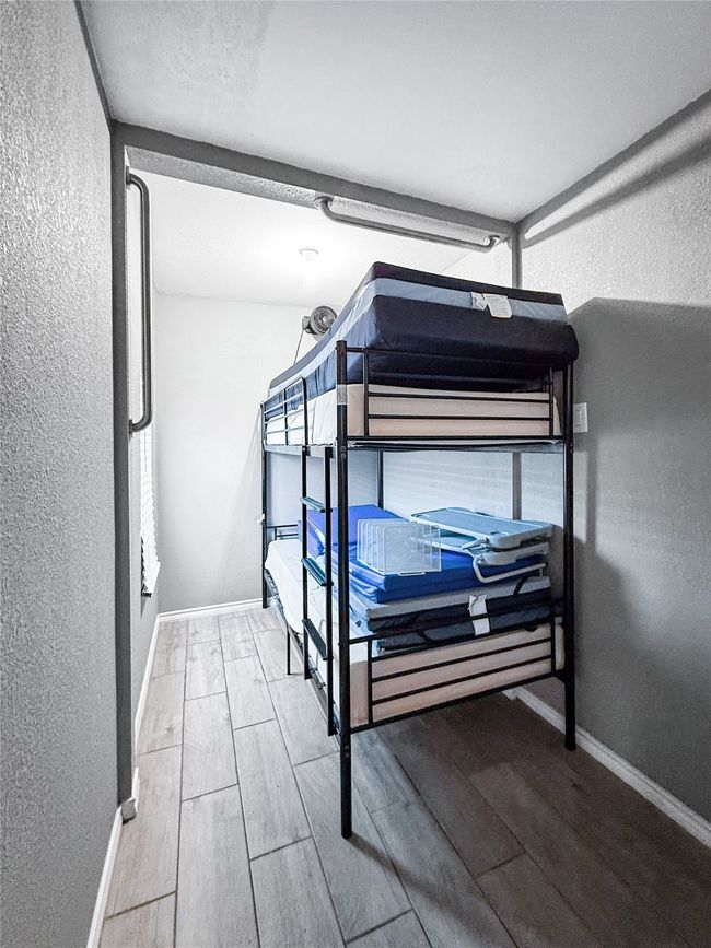 Bedroom with a textured wall and wood finish​​‌​​​​‌​​‌‌​‌‌​​​‌‌​​‌‌​‌​​​​​‌ floors | Image 28