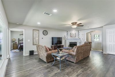 Living room featuring dark hardwood / wood-style flooring and ceiling fan | Image 3