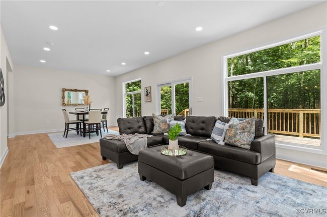 Living area with light wood-style floors and recessed lighting | Image 15
