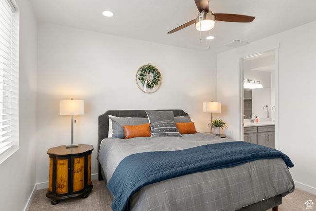 Carpeted bedroom featuring visible vents, a ceiling fan, recessed lighting, connected bathroom, and baseboards | Image 12