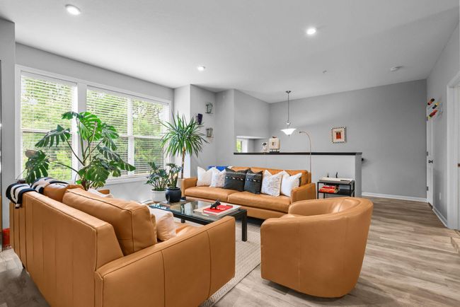 Bright and expansive are words that describe the spacious living room. | Image 4