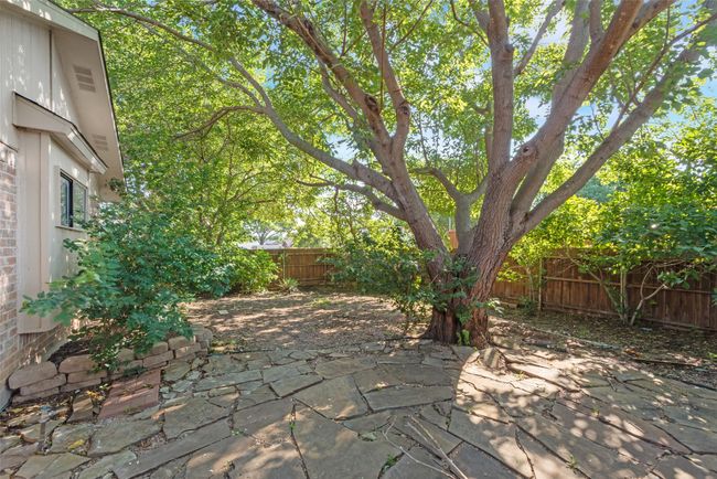 Fenced backyard with a patio area | Image 12