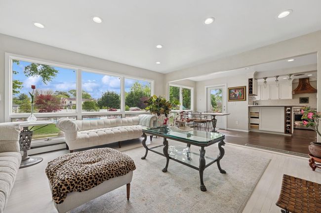 Living area featuring recessed lighting, wood finished floors, and baseboard heating | Image 16
