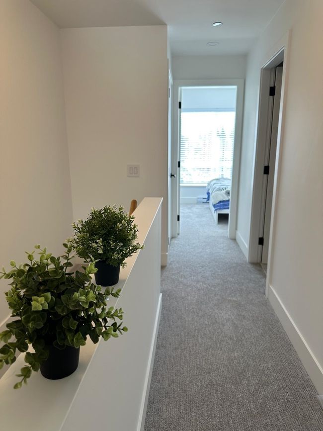 Hallway with baseboards and light carpet | Image 16