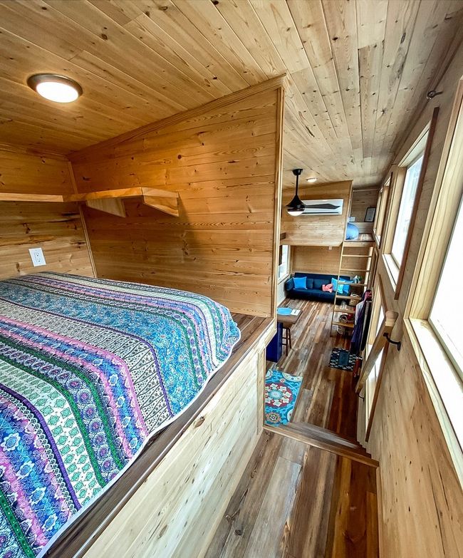 Bedroom featuring wooden ceiling, wooden walls, and hardwood / wood-style flooring | Image 35