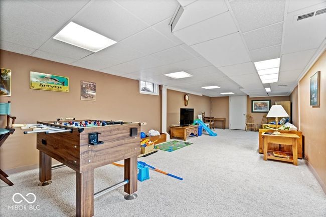 rec room featuring carpet and a paneled ceiling | Image 32