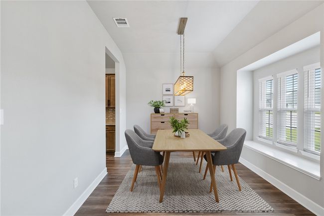 Dining area featuring baseboards, dark wood-type flooring, and lofted ceiling | Image 11