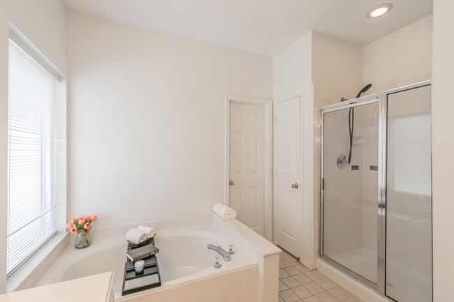 Bathroom featuring recessed lighting, a garden tub, tile patterned floors, and a stall shower | Image 32