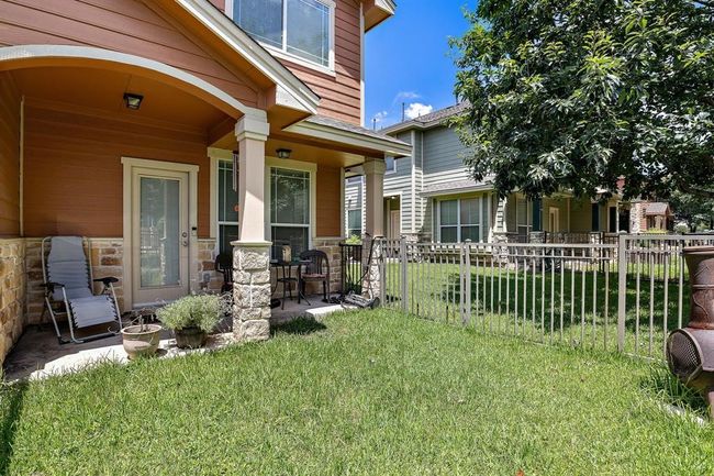 Private backyard retreat featuring a small covered patio for year-round enjoyment. | Image 17