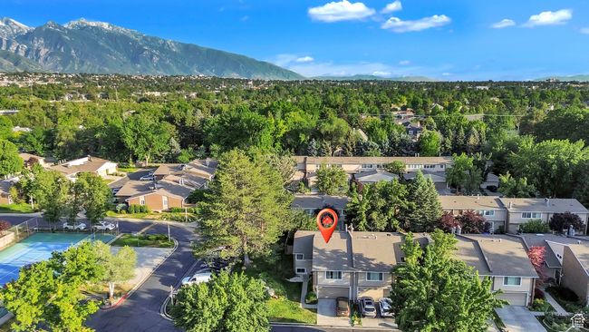 Aerial perspective of suburban area with a mountainous background and a heavily wooded area | Image 35