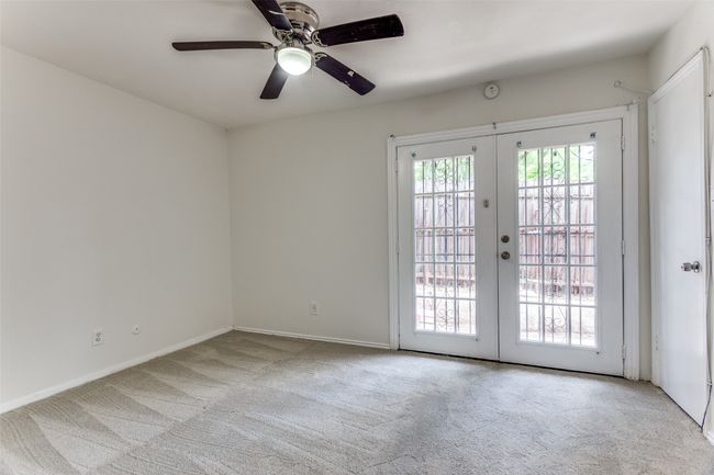 Unfurnished room featuring carpet flooring, french doors, and a ceiling fan | Image 8