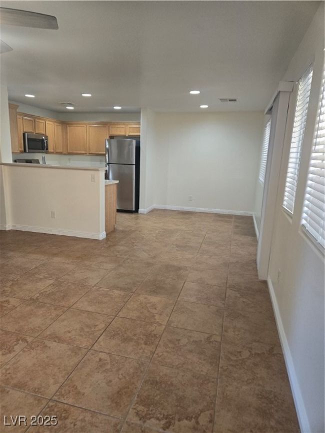 Kitchen featuring recessed lighting, open floor plan, visible vents, and refrigerator | Image 8