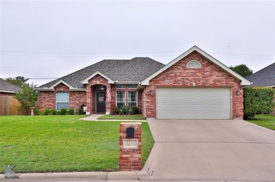 View of front of property with a garage and a front lawn | Image 1