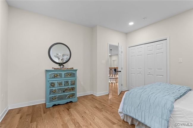Bedroom with light wood-style floors, recessed lighting, and a closet | Image 28