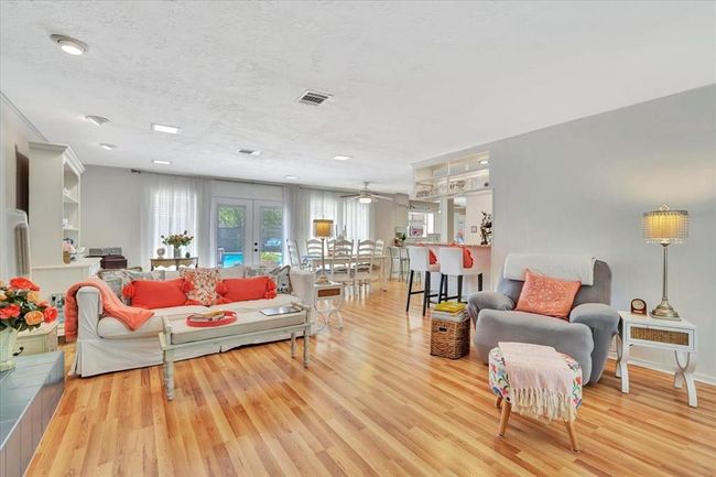 Beautiful wood like flooring sweeps throughout the downstairs living areas and you'll never get tired of the pool views! | Image 8