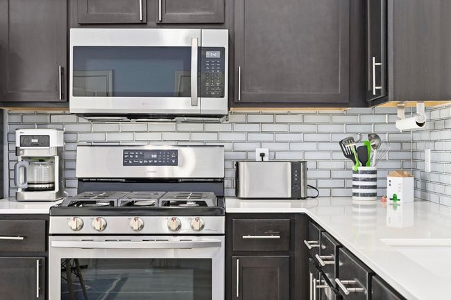 Kitchen featuring appliances with stainless steel finishes and dark brown cabinetry | Image 18