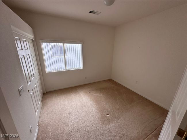 Unfurnished bedroom with light colored carpet and baseboards | Image 12