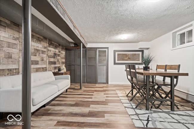 dining room with wood finished floors, a textured ceiling, and baseboards | Image 27