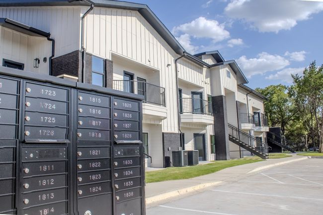 View of community featuring a balcony, uncovered parking, and mail area | Image 4