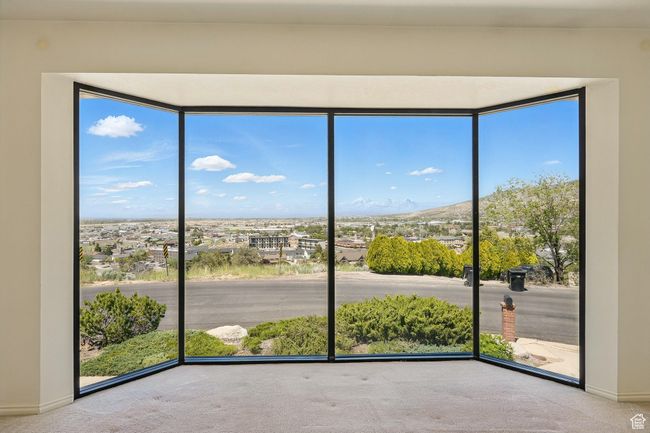 Carpeted empty room featuring healthy amount of natural light and a mountain view | Image 4