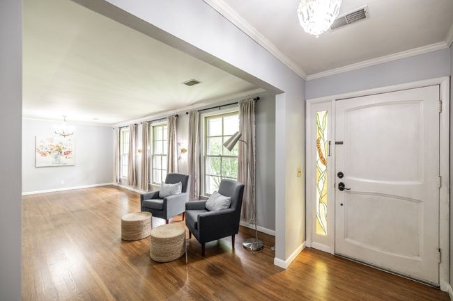 As you enter the home you are greeted by original hardwood floors. | Image 15