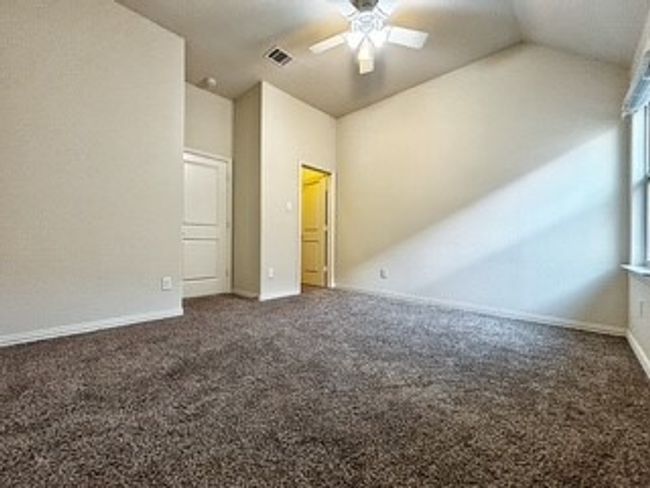 Unfurnished bedroom featuring lofted ceiling, carpet floors, and a ceiling fan | Image 18