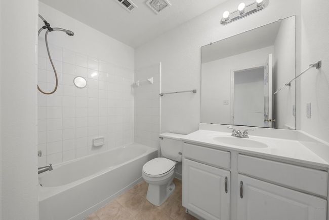 Bathroom with visible vents, toilet, vanity, and tile patterned flooring | Image 17