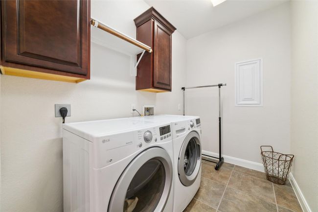 Laundry room is just across from the breakfast area. | Image 19