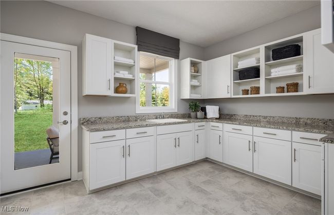 Large main floor laundry room with direct access to the rear covered porch and yard. | Image 5