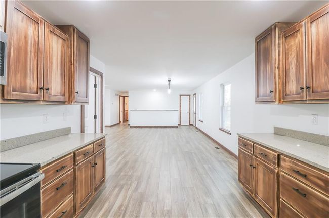 Kitchen featuring light stone countertops and light hardwood / wood-style floors | Image 8