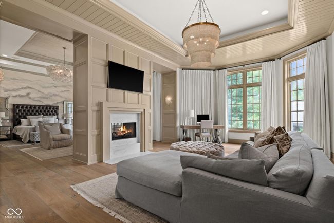 primary sitting area featuring a tray ceiling, and ornamental molding | Image 25