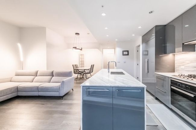 Kitchen featuring modern cabinets, oven, a sink, and white gas stovetop | Image 4