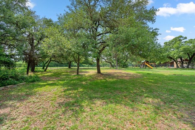 View of yard featuring fence and playground community | Image 36