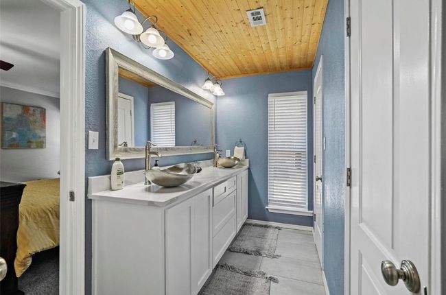 Primary bath with gorgeous wood ceilings and dual vanity | Image 15