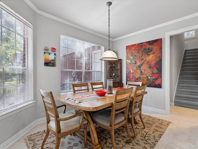 Dining area with plenty of natural light, stairs, ornamental molding, and light tile patterned floors | Image 13