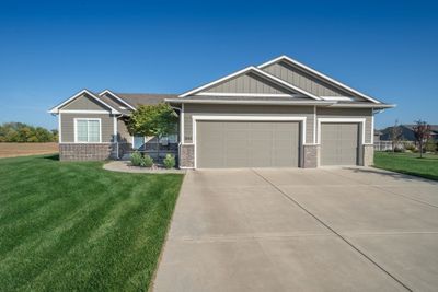 Craftsman-style home with a front yard and a garage | Image 1